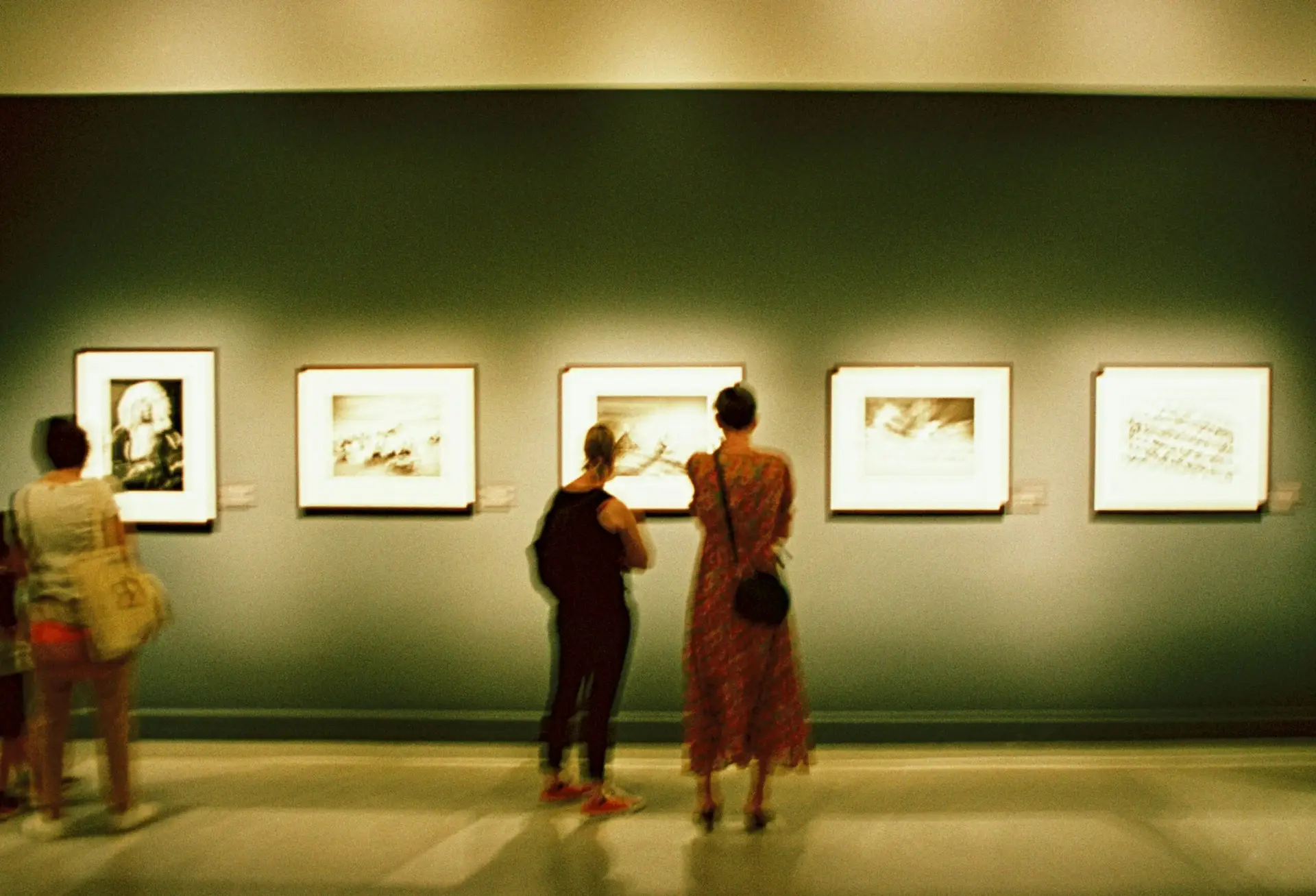 Two people appreciate a canvas at an art gallery
